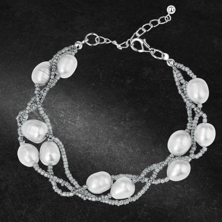 Dove Silver Pearl Bracelet featuring delicate gems and intertwined silver beads, designed for a refined and elegant female jewelry collection.