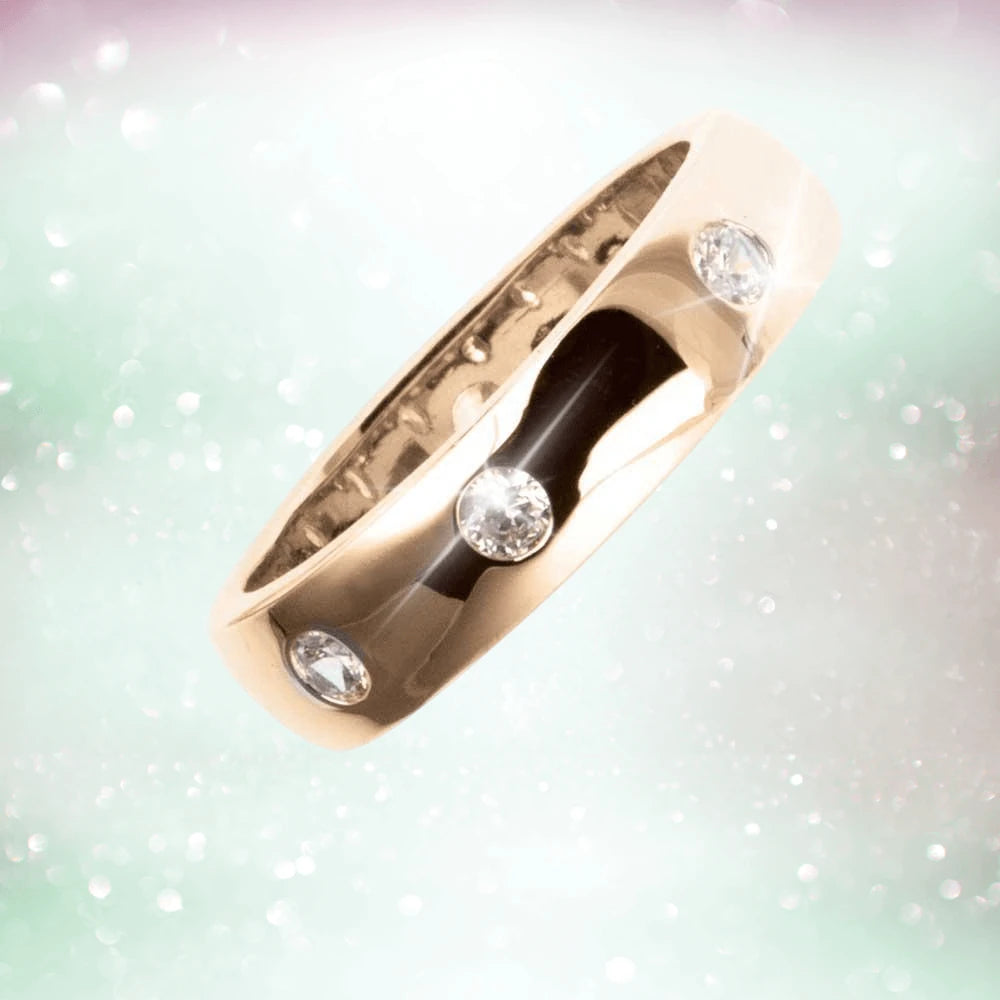Puccini Ring Rose Gold featuring a sleek sterling silver band plated in rose gold, adorned with sparkling clear gemstones, designed as a unisex jewelry piece.