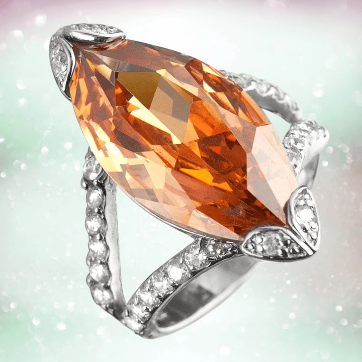 Marquise Champagne Ring featuring a large marquise-cut champagne gemstone set in sterling silver with rhodium plating and a band adorned with small sparkling stones, designed for women.
