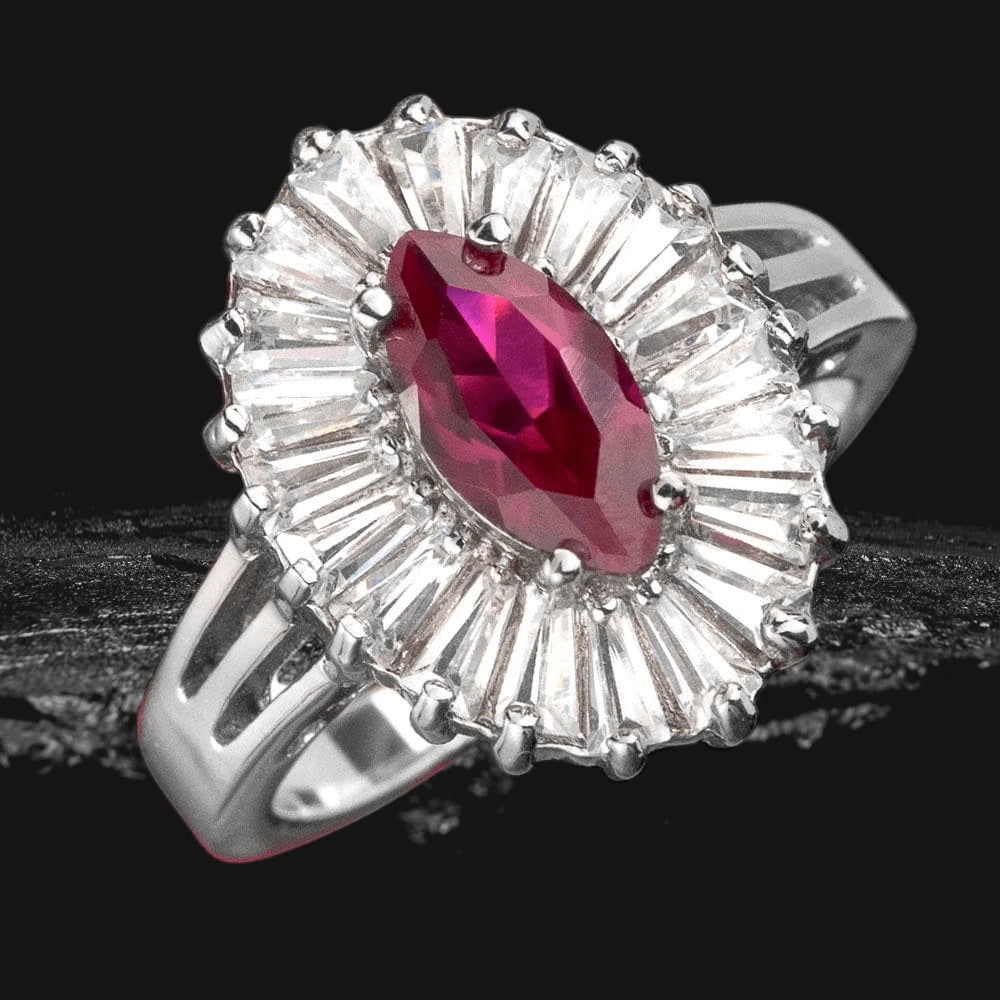 Hampton Ring featuring a marquise red gemstone centerpiece surrounded by radiant clear stones, crafted in sterling silver with rhodium plating for a luxurious finish.