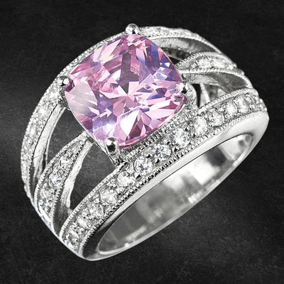 Padua Ring featuring a large pink gemstone set in sterling silver with intricate bands accented by smaller sparkling stones, designed for female jewelry enthusiasts.