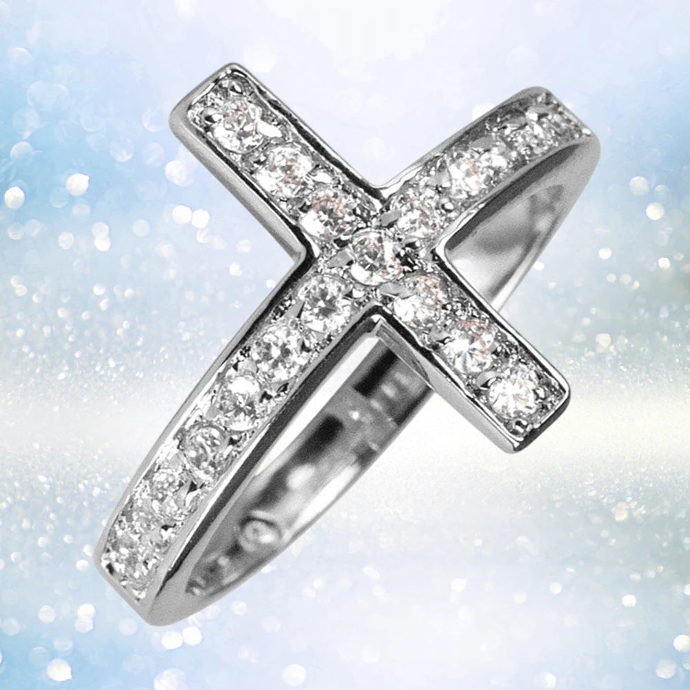 Reclining Cross Rhodium Ring made of sterling silver with rhodium plating, featuring sparkling stones set in a female-designed cross-shaped band, perfect as elegant jewelry.