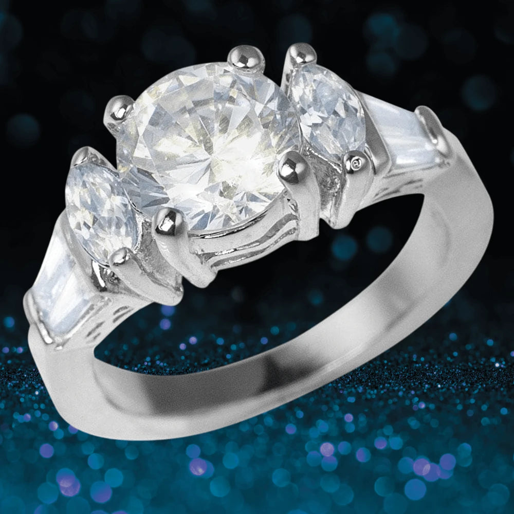 Bellini Rhodium Ring featuring a sterling silver band with a large round central stone flanked by two marquise-cut and two tapered baguette-cut stones, designed for women’s jewelry.