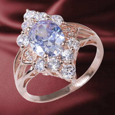 Zarina Ring featuring sterling silver with rose gold plating, adorned with a large faceted oval gemstone surrounded by sparkling clear crystals in an elegant design for women.