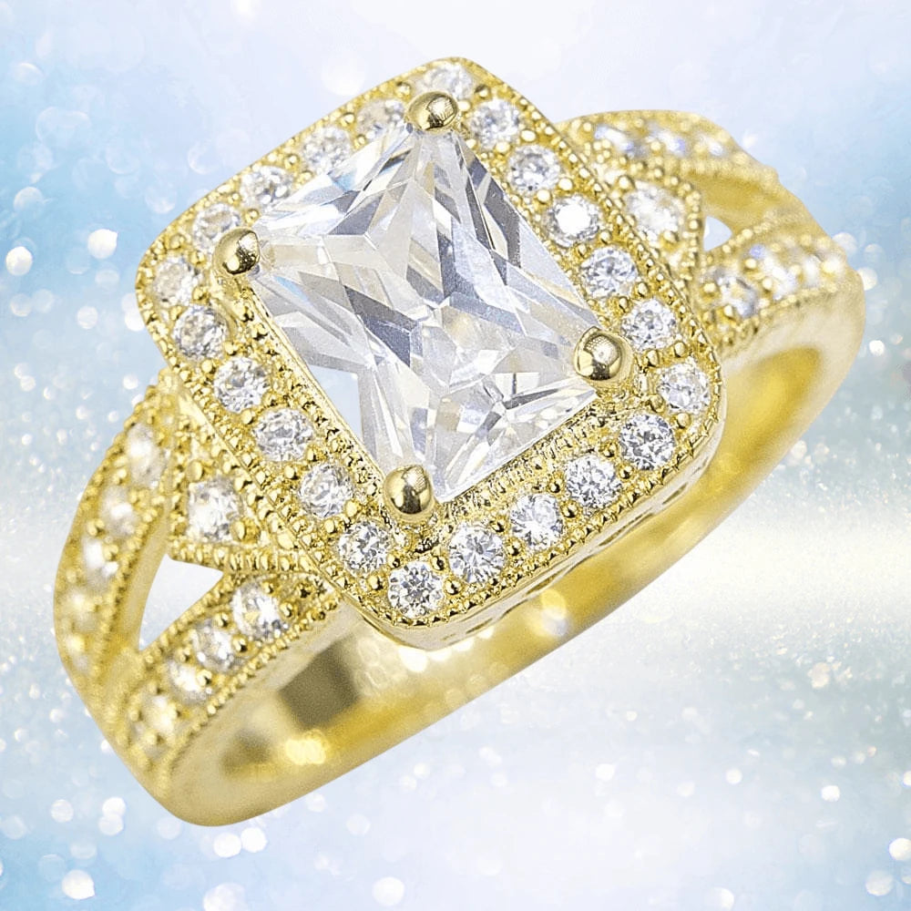 Siam Ring featuring a large rectangular clear gemstone set in a sterling silver band with gold plating, adorned with small clear stones for an elegant jewelry piece for females.