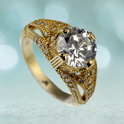 Eldorado Ring featuring a large round clear gemstone set in sterling silver with gold plating, designed for women with intricate detailing and smaller accent stones.