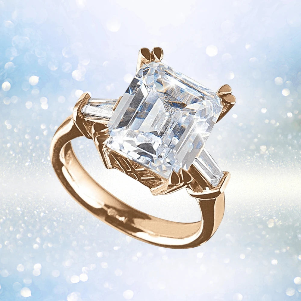 Billionaire Rose Gold Ring featuring a sterling silver band plated in rose gold with a large emerald-cut center gemstone and two tapered baguette side stones, designed for women.