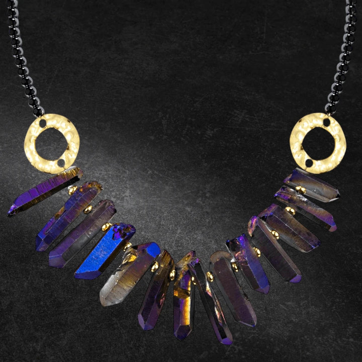 Hematite Crystal Necklace with iridescent crystal gems hanging from a white base metal chain designed for female jewelry, featuring hammered gold-tone circular accents.