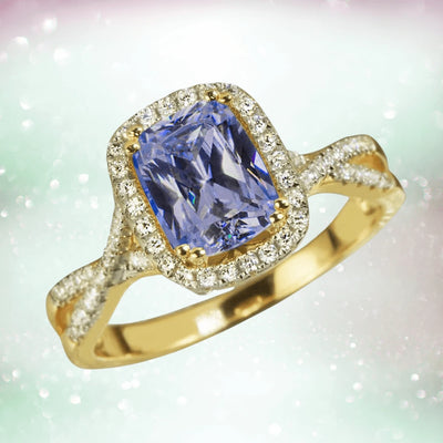 Tanzanite Twist Ring featuring a radiant tanzanite center stone set in a sterling silver band plated in gold, accented with sparkling diamonds for an elegant female jewelry piece.