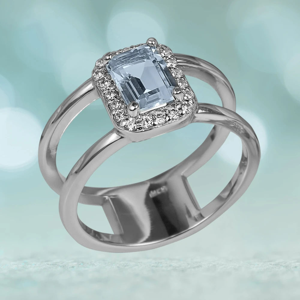 Destiny Topaz Ring featuring a rectangular light blue topaz center stone surrounded by small clear stones, set in rhodium-plated sterling silver designed for female jewelry.