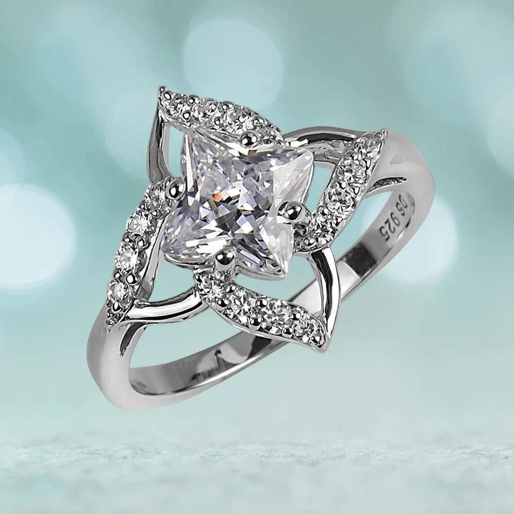 Starfire Ring featuring a sterling silver band with rhodium plating, highlighted by a brilliant princess-cut center stone surrounded by intricate smaller stones, designed for women.