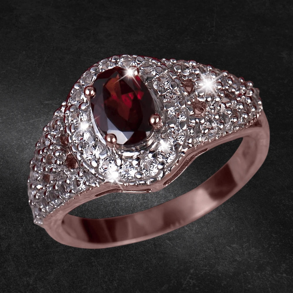 Rouge Garnet Ring featuring a deep red garnet centerpiece surrounded by sparkling white stones set in polished stainless steel, designed for female jewelry elegance.