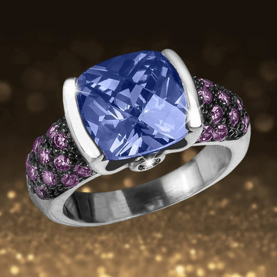 Rainforest Rhodium Ring featuring a large blue cushion-cut gemstone set in sterling silver with rhodium plating, accented by small purple stones for a striking female jewelry piece.