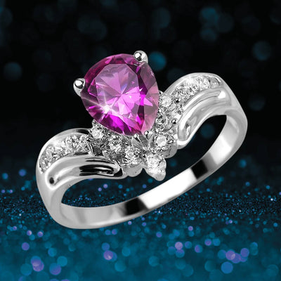 Rosa Primera Ring featuring a pear-shaped pink gemstone set in rhodium-plated sterling silver with accenting clear stones, designed for women’s jewelry collections.