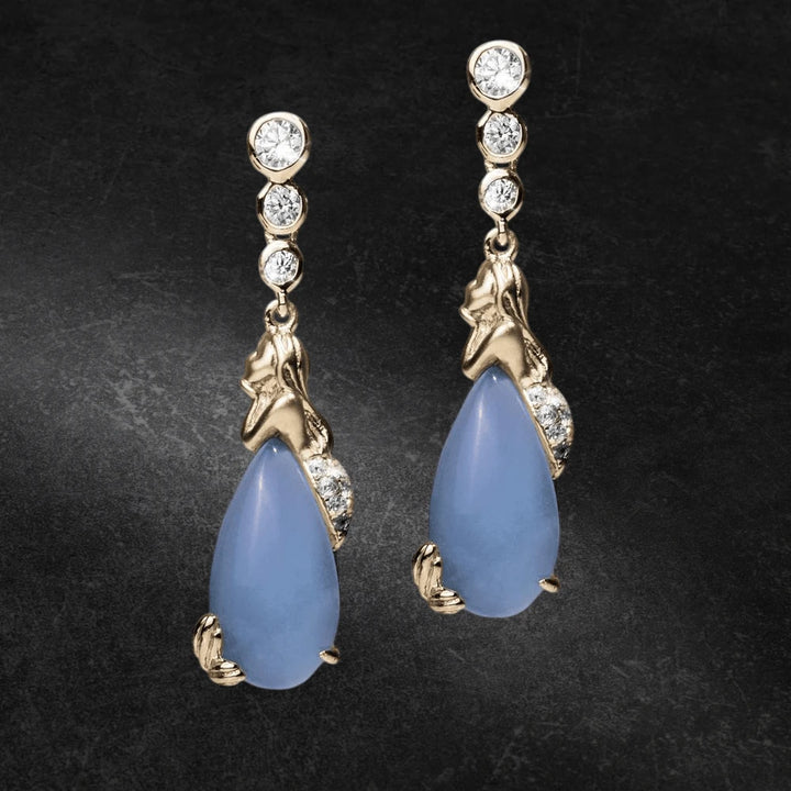 Pair of Mermaid Lagoon Earrings featuring gold-plated sterling silver mermaid design with blue teardrop stones and sparkling round crystals, elegant jewelry for women.
