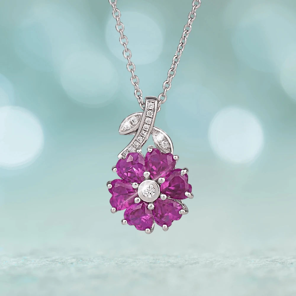 Charlotte Pendant featuring a sterling silver setting with rhodium plating, showcasing a floral design with vibrant pink gemstones and sparkling diamond accents on a delicate chain.