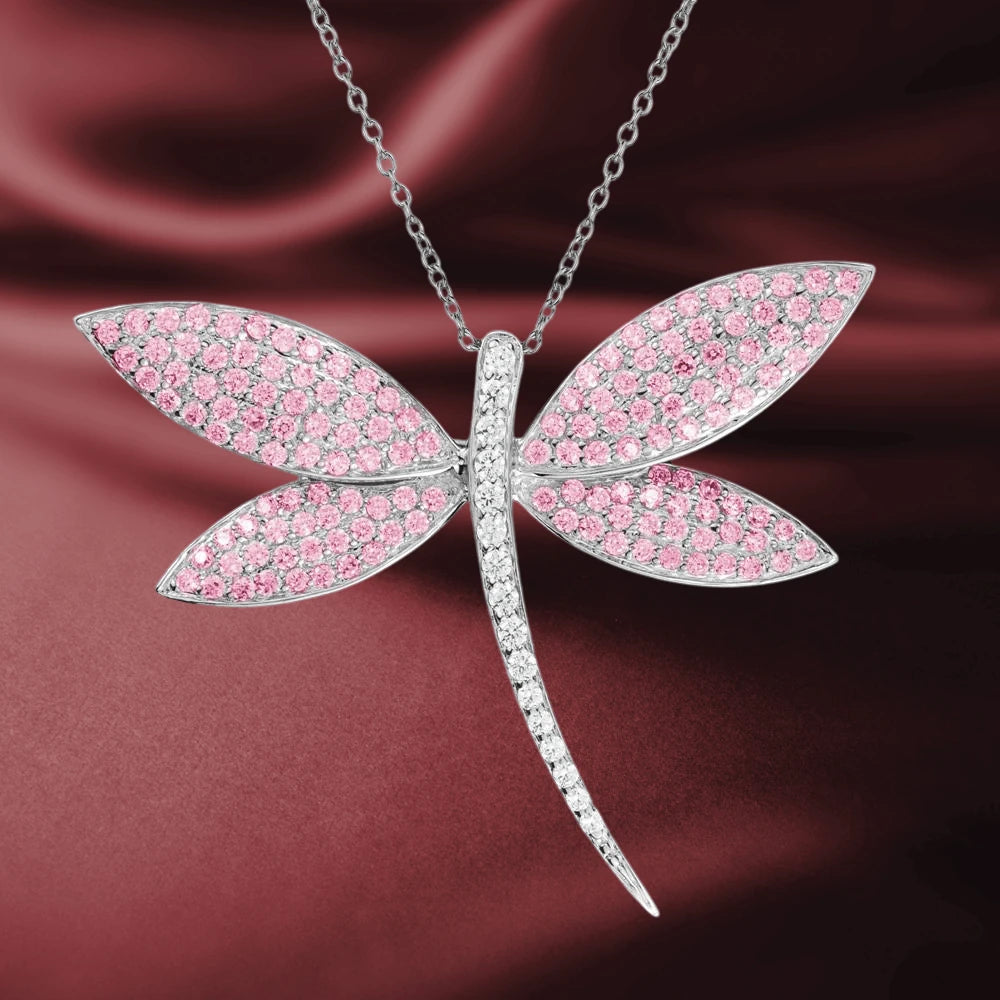 Fly Away Brooch Pink sterling silver brooch with rhodium plating featuring a dragonfly design adorned with sparkling pink stones, elegant jewelry for women.