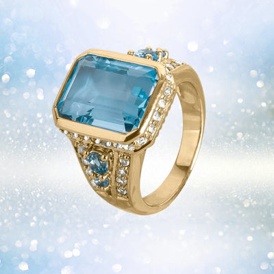 Bermuda Blue Topaz Ring featuring a large rectangular blue topaz gemstone set in sterling silver with gold plating, adorned with small sparkling stones, designed for females.