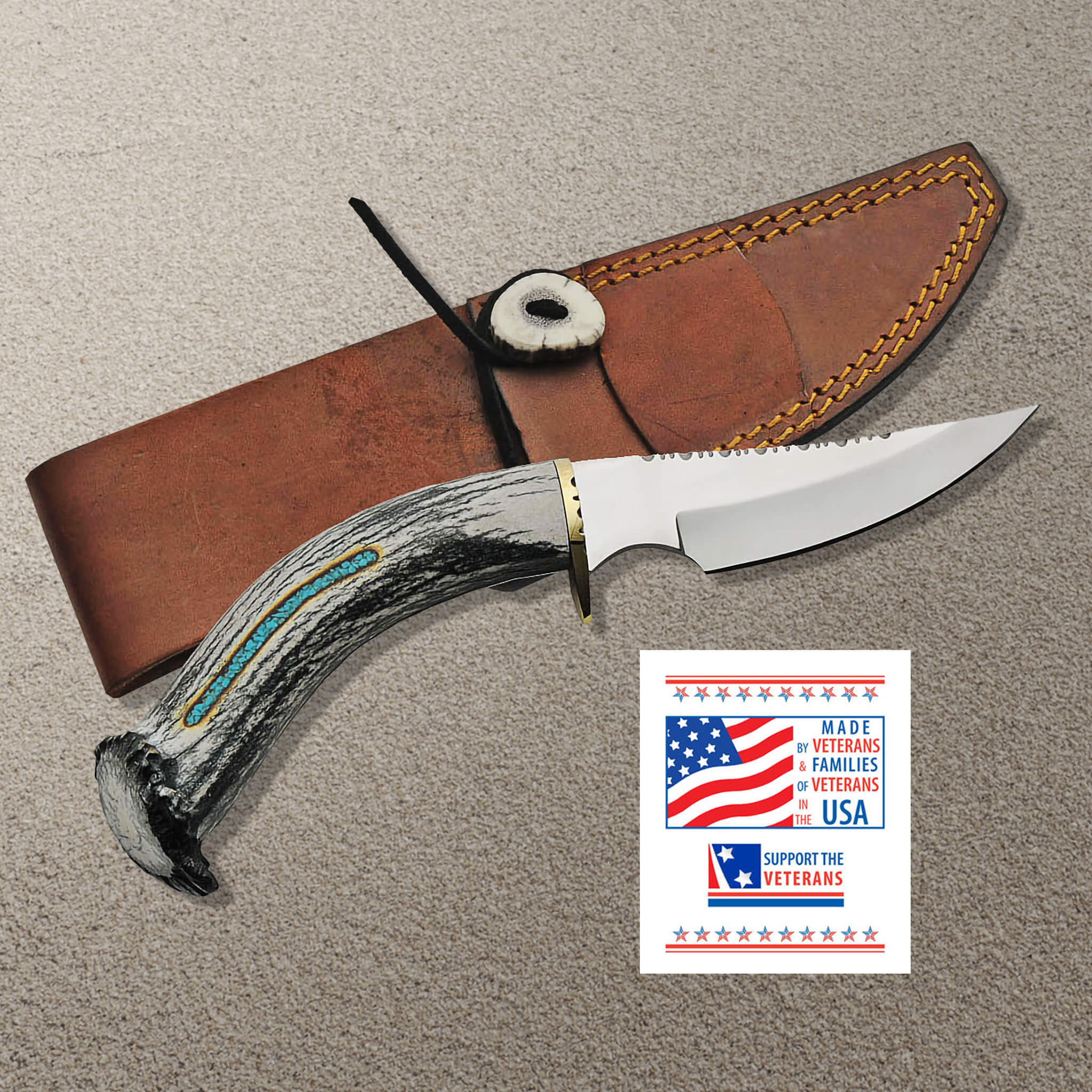 Veteran's Legacy Knife with stainless steel blade and antler handle, accompanied by a stitched leather sheath and a card supporting veterans, Up To 75% Off Retail.