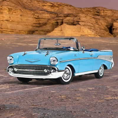 1957 Chevy Bel Air - Larkspur Blue convertible classic car parked on desert terrain with rocky cliffs in the background under a clear sky
