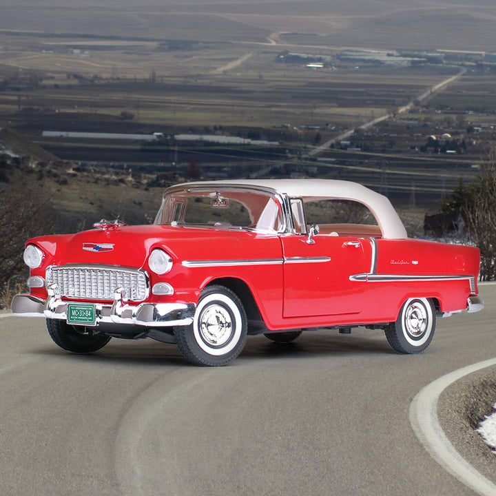 Red die cast 1955 Chevrolet Bel Air Convertible - Red model car displayed on a winding road with scenic background, unisex collectible, Up To 75% Off Retail.
