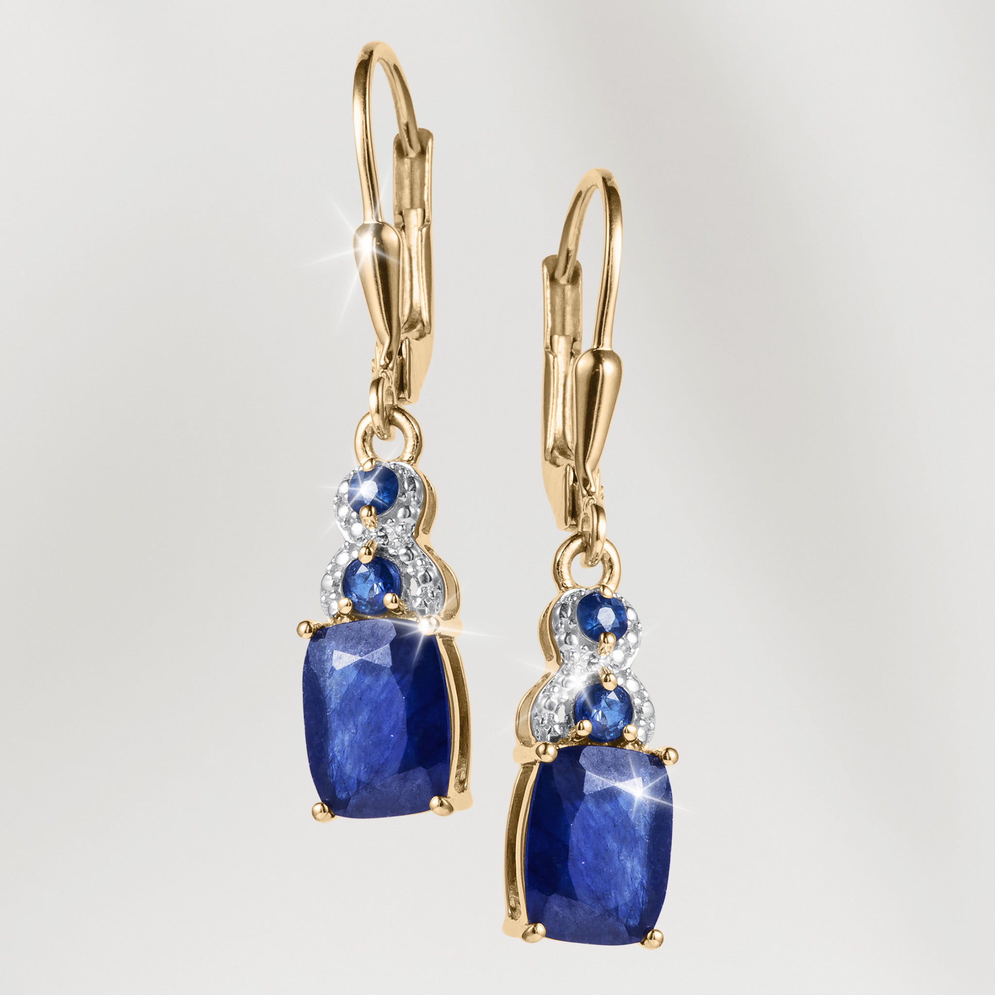 Elara Sapphire Earrings featuring gold drop settings with deep blue sapphire stones and sparkling clear accents for an elegant jewelry look