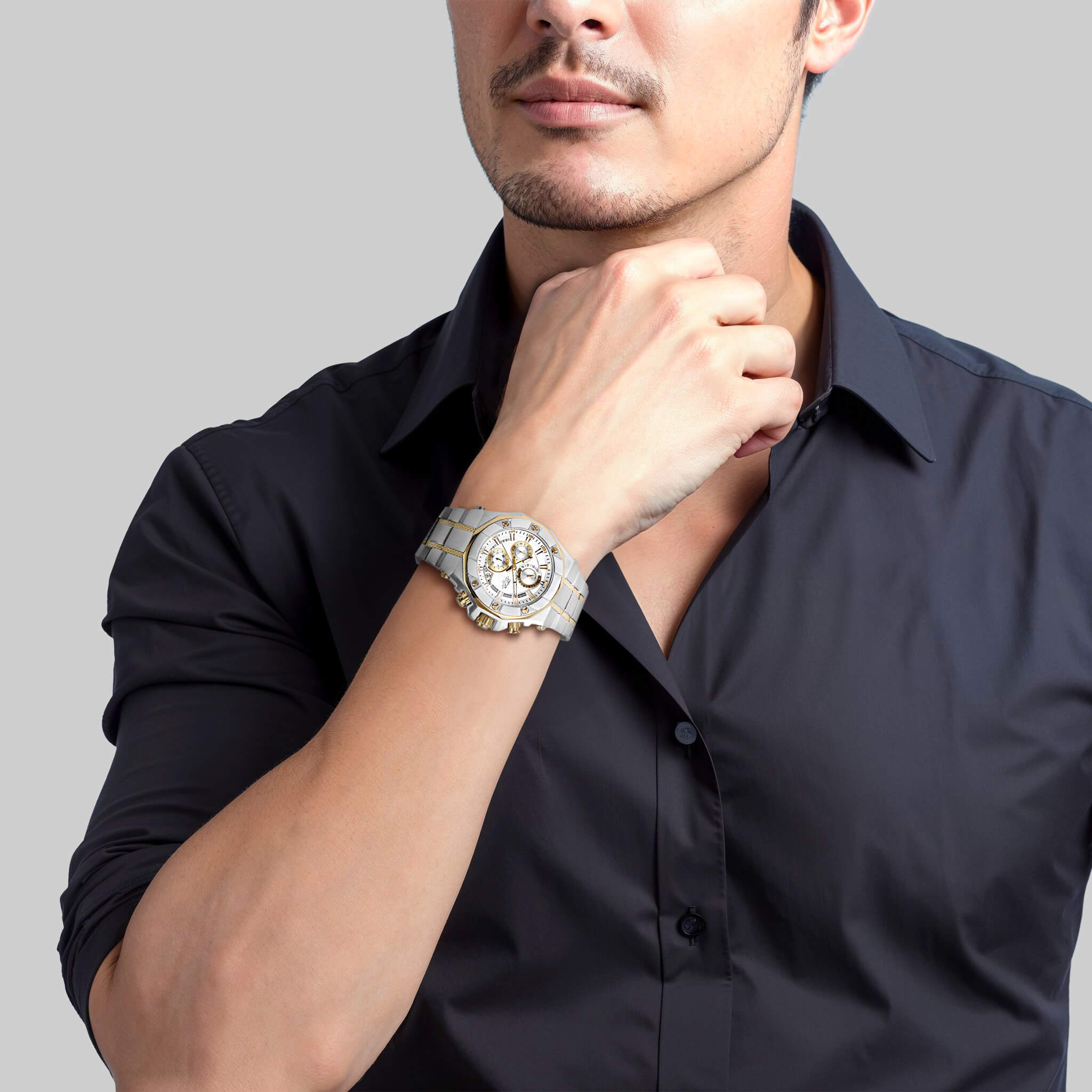 Man wearing a Phantom Two-Tone Men's Watch with a silver dial and stainless steel two-tone plating, styled with a black dress shirt for a sophisticated look.