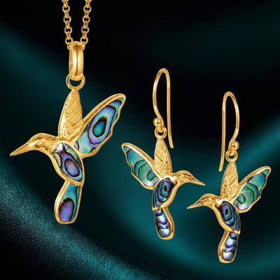 Elegant pair of gold hummingbird earrings and matching pendant with iridescent abalone inlay from the Golden Abalone Hummingbird Collection, featuring intricate detailing.
