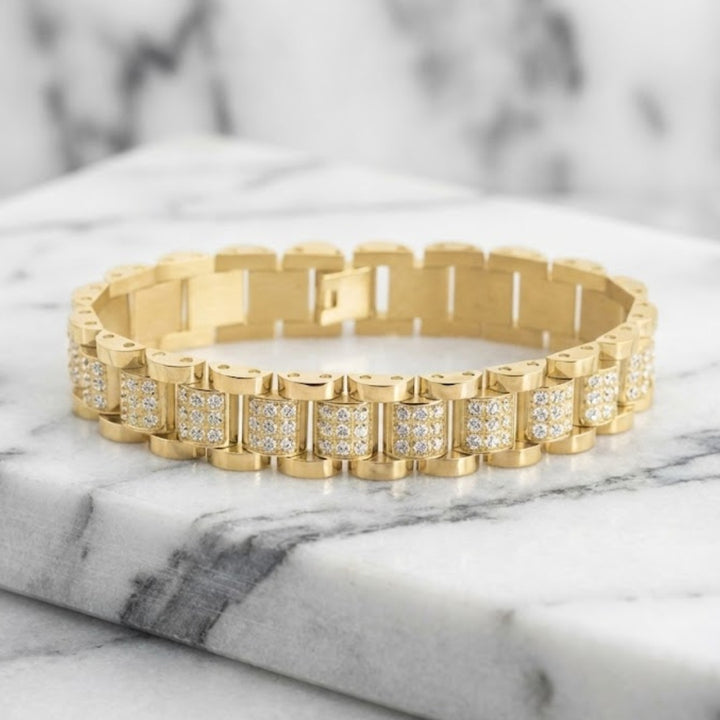Gold bracelet with diamond accents on a marble surface. Daniel Steiger Marcos Men's Bracelet