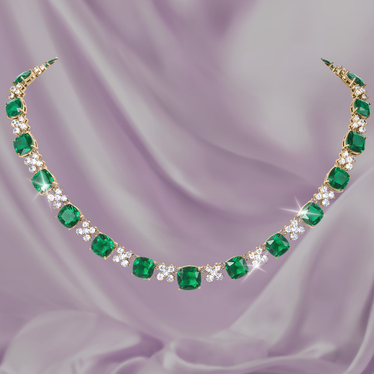 Freya Collection emerald green gemstone necklace with sparkling diamond accents displayed on lavender satin Up To 75% Off Retail