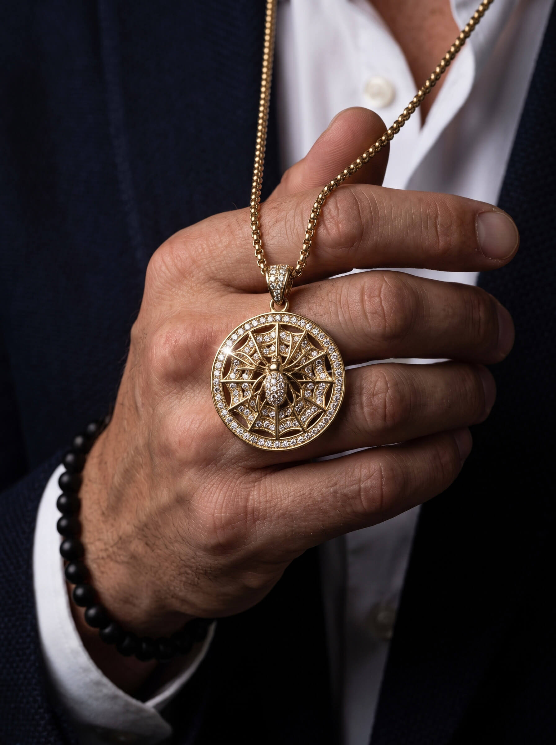 The Webmaster Pendant ornate circular gold necklace pendant with intricate web design and sparkling accents held in a hand Up To 75% Off Retail