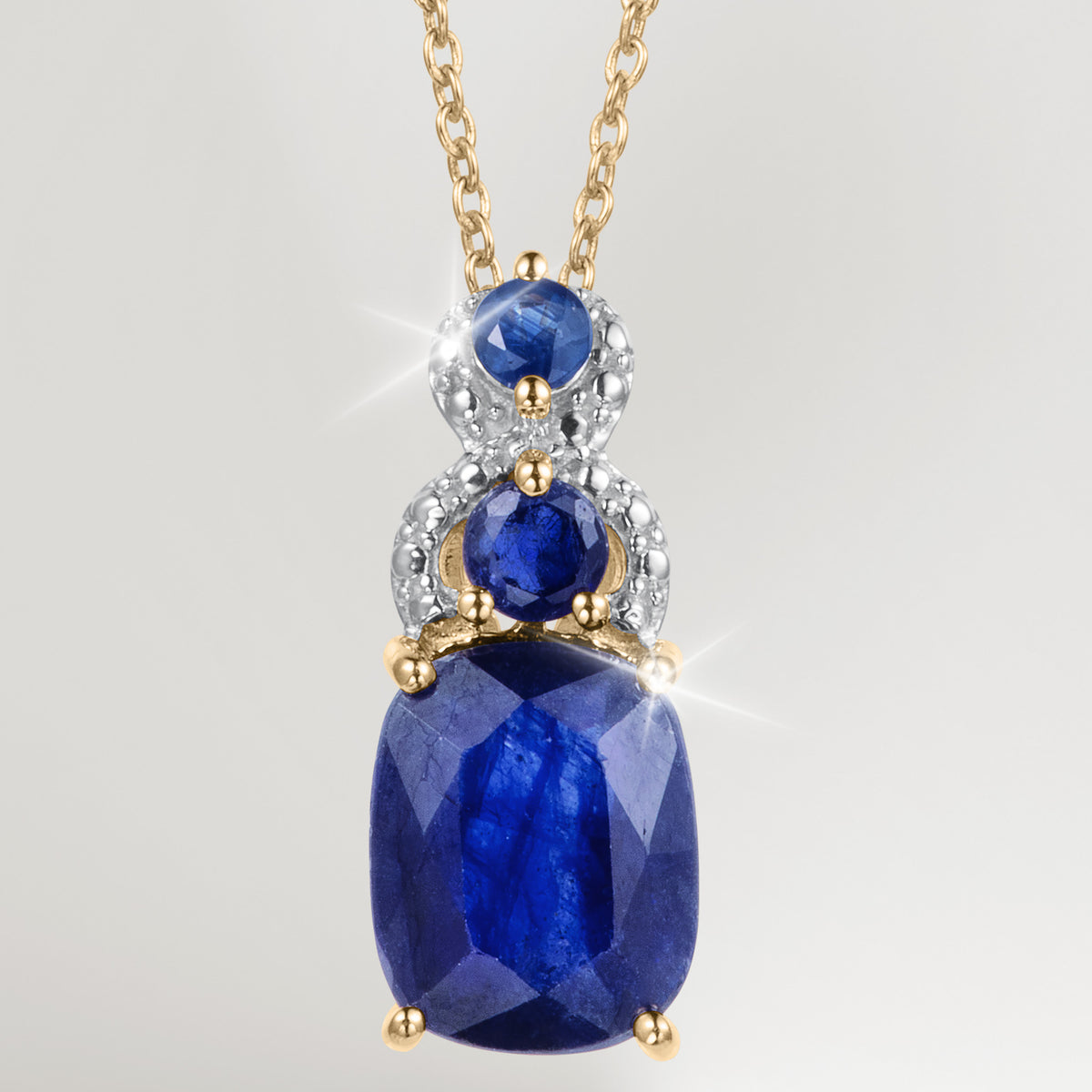 Elara Sapphire Pendant featuring faceted blue sapphire gemstones in a gold tone setting with sparkling accents on a delicate chain Up To 75% Off Retail