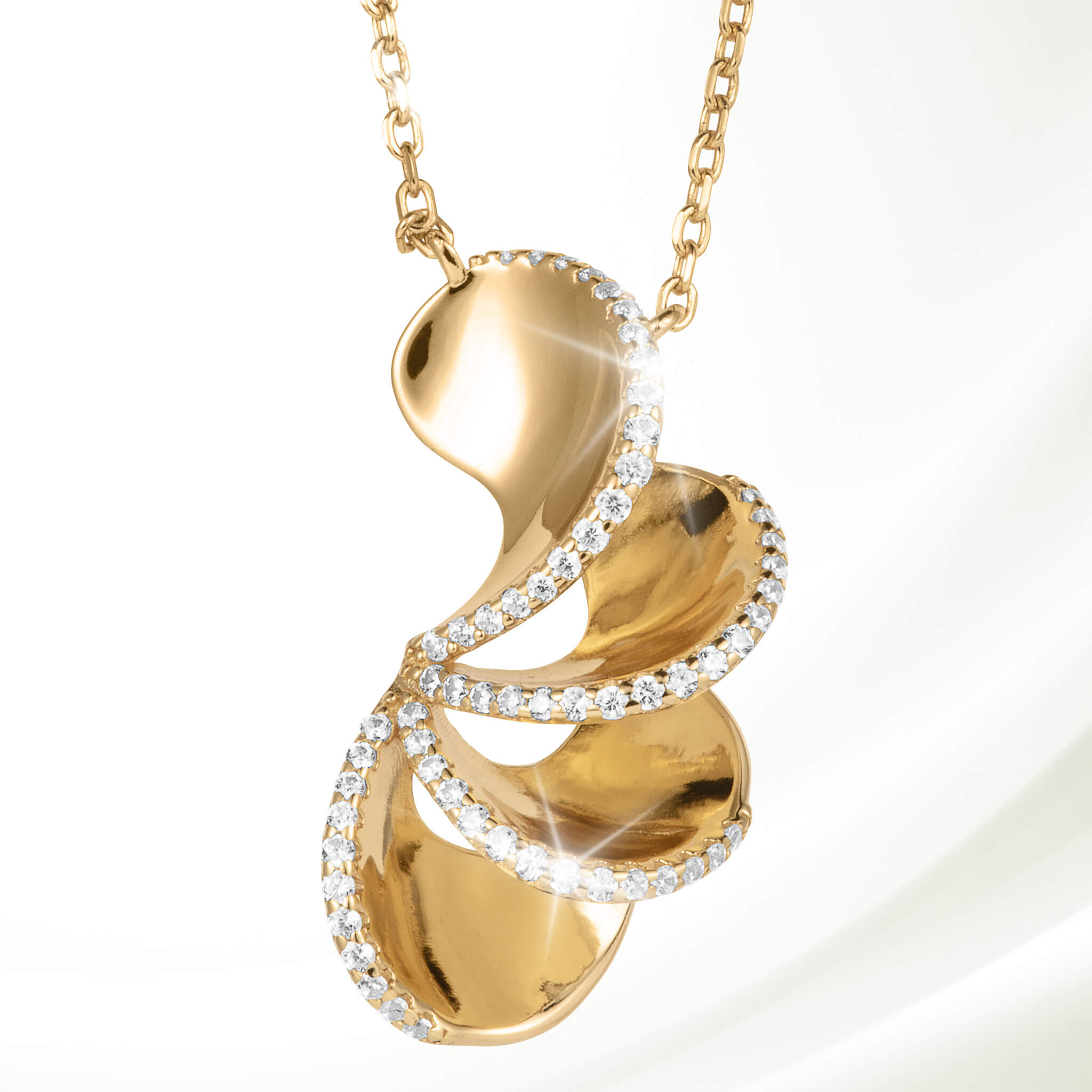 Elegant gold pendant necklace from the Arianna Collection featuring a flowing design accented with sparkling crystals, available Up To 75% Off Retail.