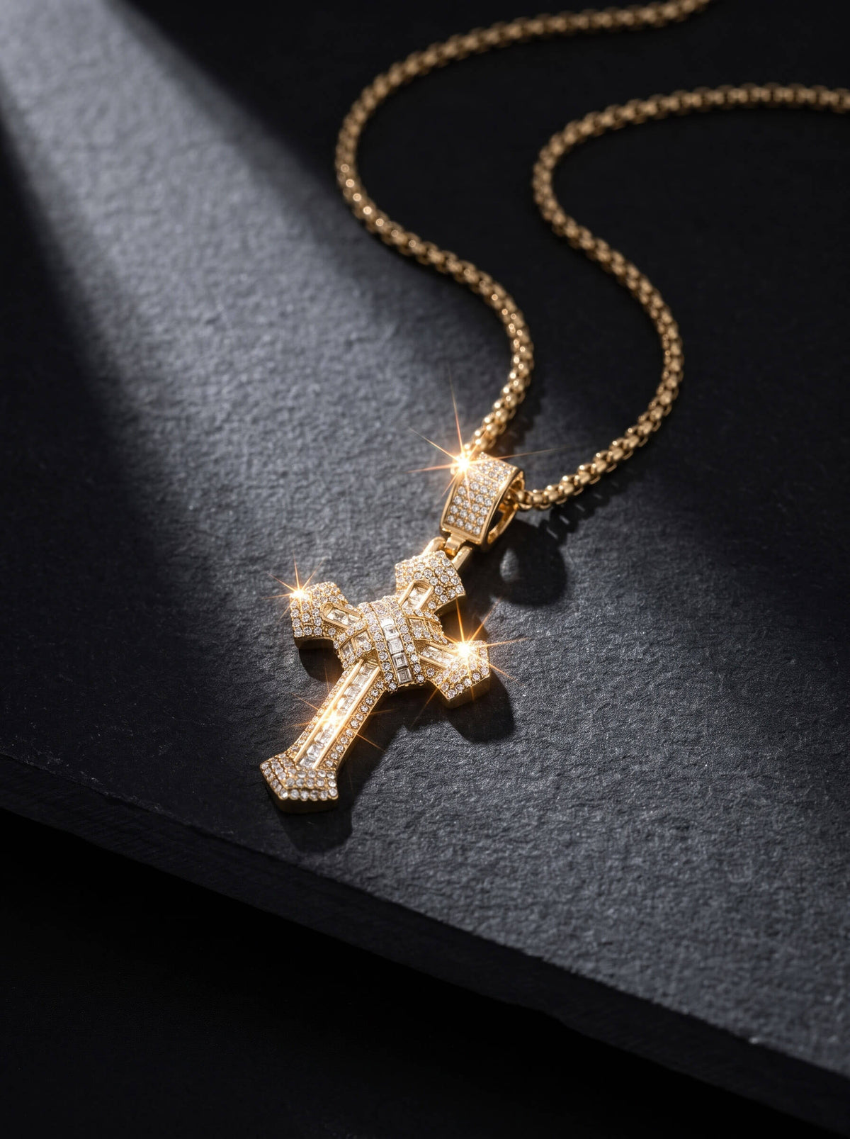 Redemption Pendant gold cross necklace with sparkling crystal details and a textured chain displayed on black fabric for a bold elegant jewelry statement