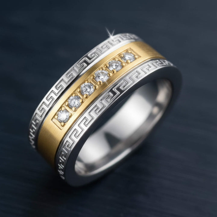 Men's Empire Ring featuring a two-tone stainless steel band with intricate Greek key pattern edges and a row of seven clear gemstones embedded in the center.