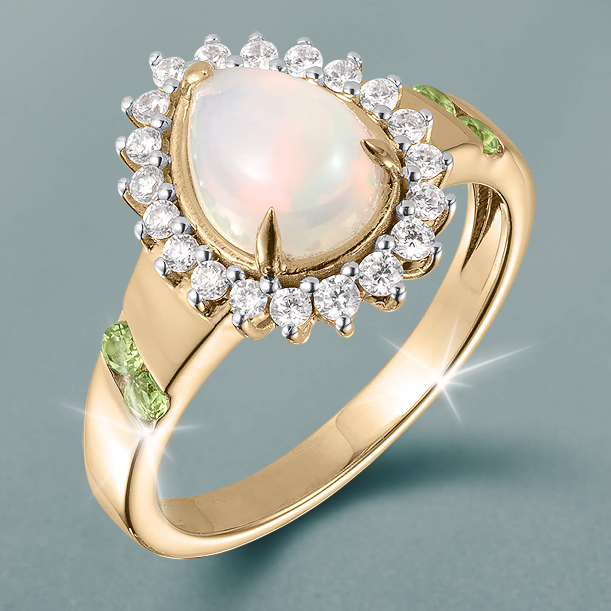 Opal Dew Drop Collection Set ring with luminous opal center, sparkling halo, and green gemstone accents, offered at Up To 75% Off Retail