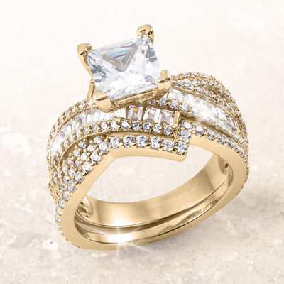 Amore Lumiere Bridal Ring in gold plating featuring a large square-cut center stone with intricate rows of smaller round and baguette crystals, up to 75% off retail.