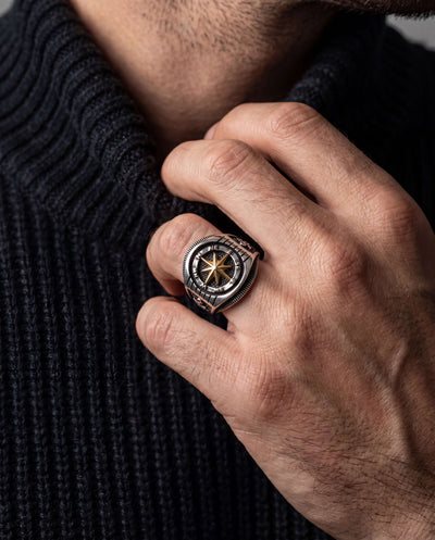 Navigator Men's Ring featuring a sterling silver two-tone compass design, worn on a man's hand over a dark textured sweater, Up To 75% Off Retail.
