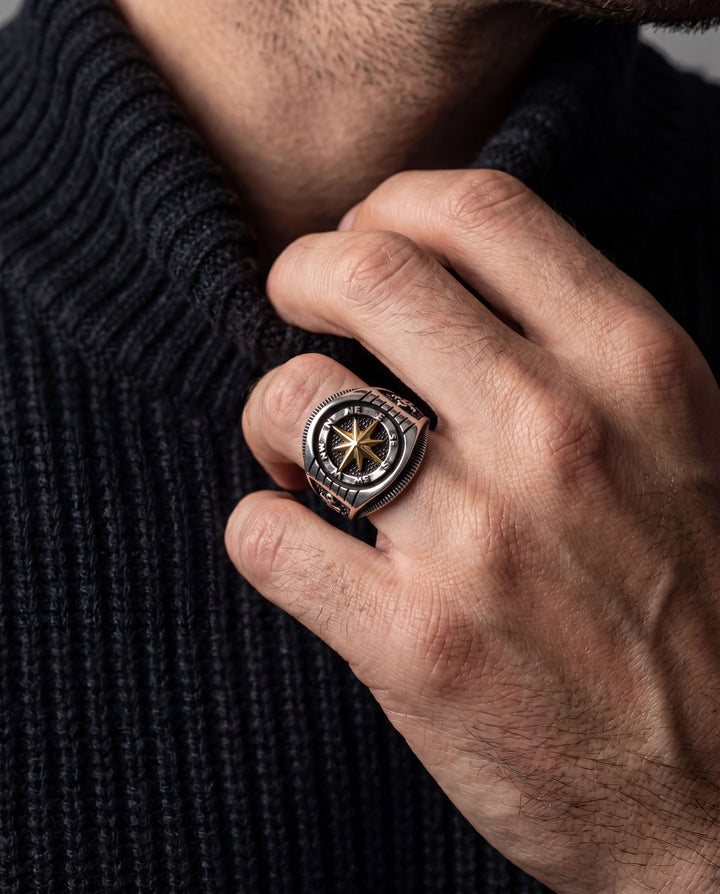 Navigator Men's Ring featuring a sterling silver two-tone compass design, worn on a man's hand over a dark textured sweater, Up To 75% Off Retail.