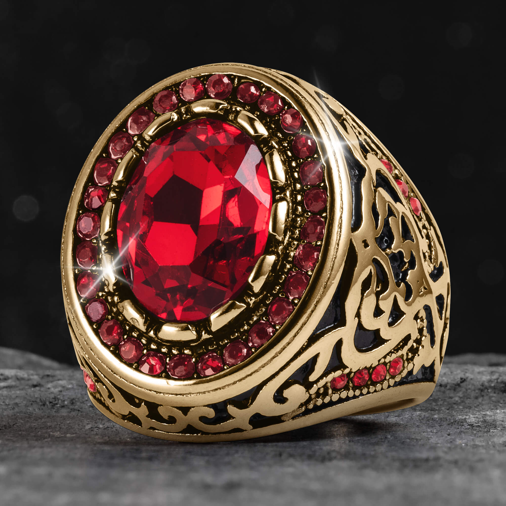 Gold ring with a red gemstone on a dark background