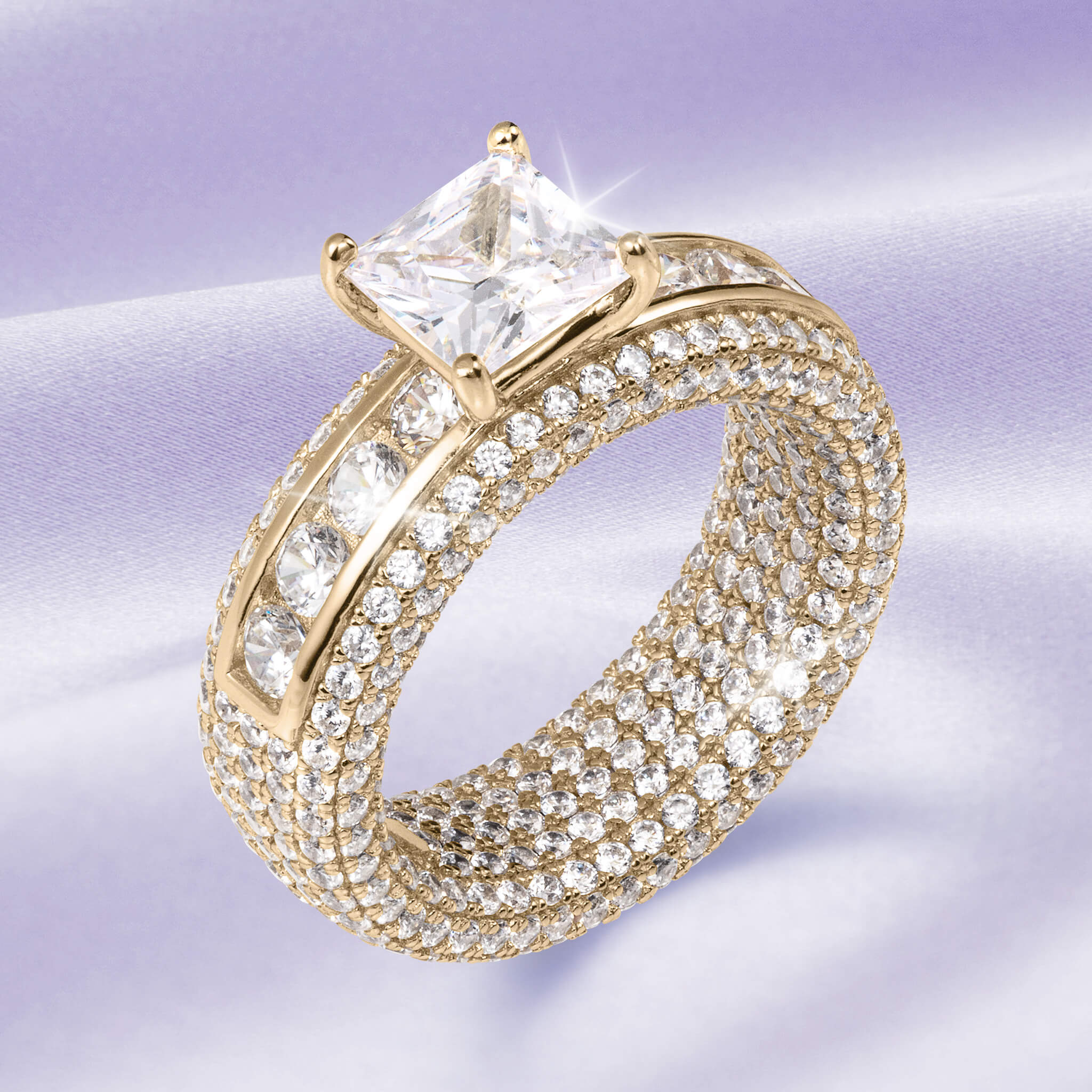 Charlotte Ladies Ring in gold with a large square-cut central stone and rows of smaller sparkling stones, showcasing luxurious elegance and offering Up To 75% Off Retail.