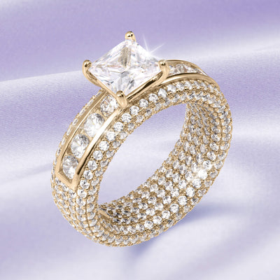 Charlotte Ladies Ring in gold with a large square-cut central stone and rows of smaller sparkling stones, showcasing luxurious elegance and offering Up To 75% Off Retail.