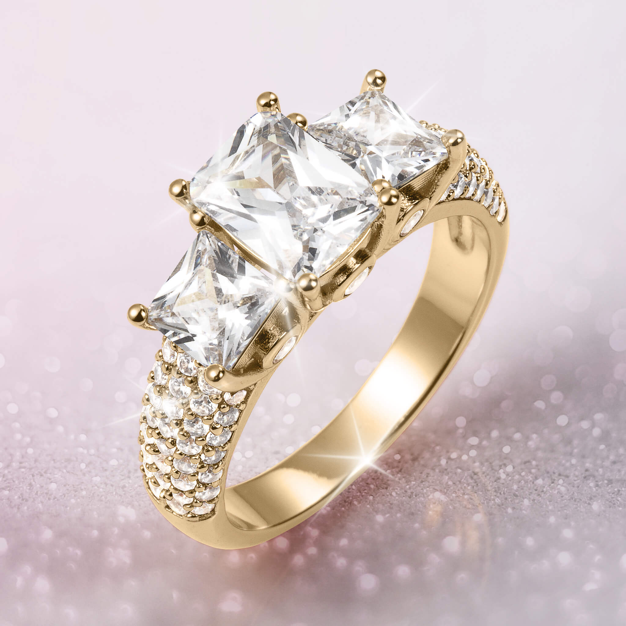Verity Ladies Ring featuring a gold band with three large clear stones and multiple smaller stones along the shoulders, offering elegance Up To 75% Off Retail.