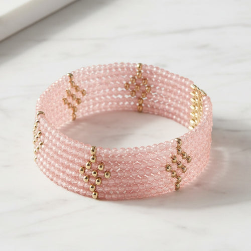 Pink beaded bracelet with gold accents on a light background. Rosa Cascade Bracelet