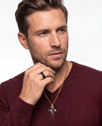 Male model wearing a gold-plated black cross pendant necklace and black ring from the Noir Legacy Collection, showcasing stylish jewelry with Up To 75% Off Retail.