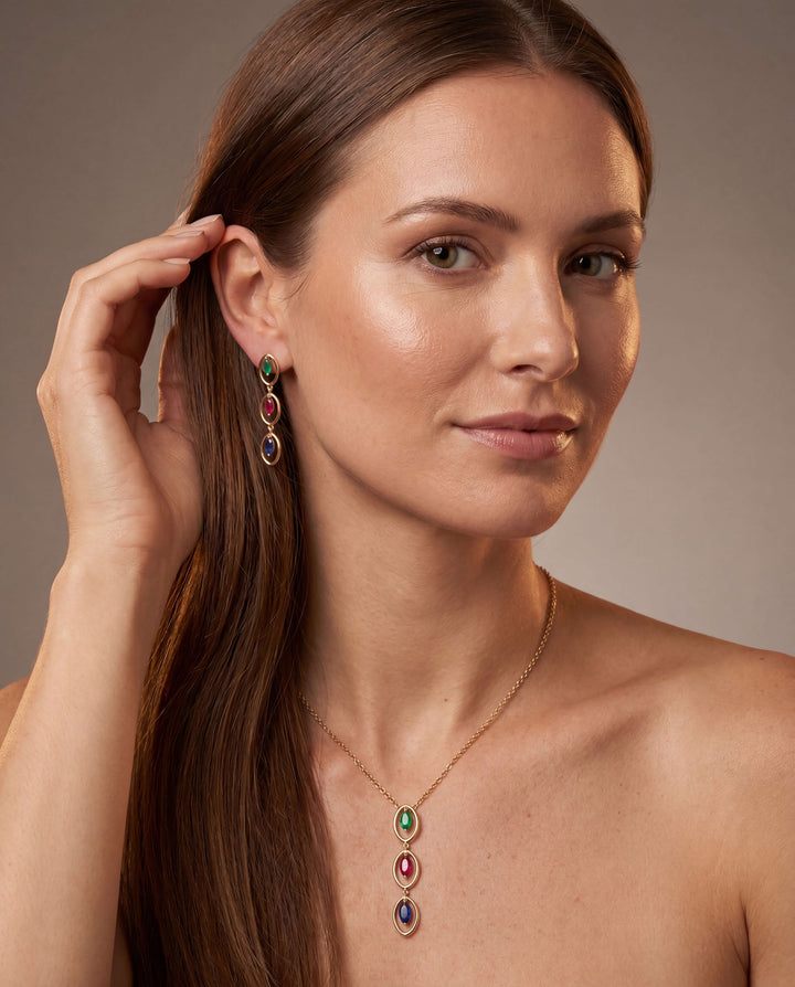 Woman wearing Trinity Royale Pendant necklace in gold plated sterling silver with green, red, and blue gemstones, showcasing elegant jewelry for female style. Up To 75% Off Retail.