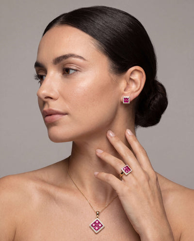 Woman wearing Rouge Lumiere Ruby Earrings in sterling silver with gold plating, showcasing elegant ruby jewelry with matching ring and pendant, Up To 75% Off Retail.