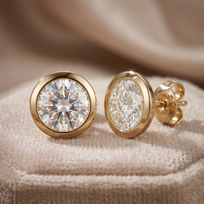 Luxe Solitaire Earrings featuring sterling silver with gold plating, showcasing sparkling solitaire stones on a soft beige fabric background, Up To 75% Off Retail.