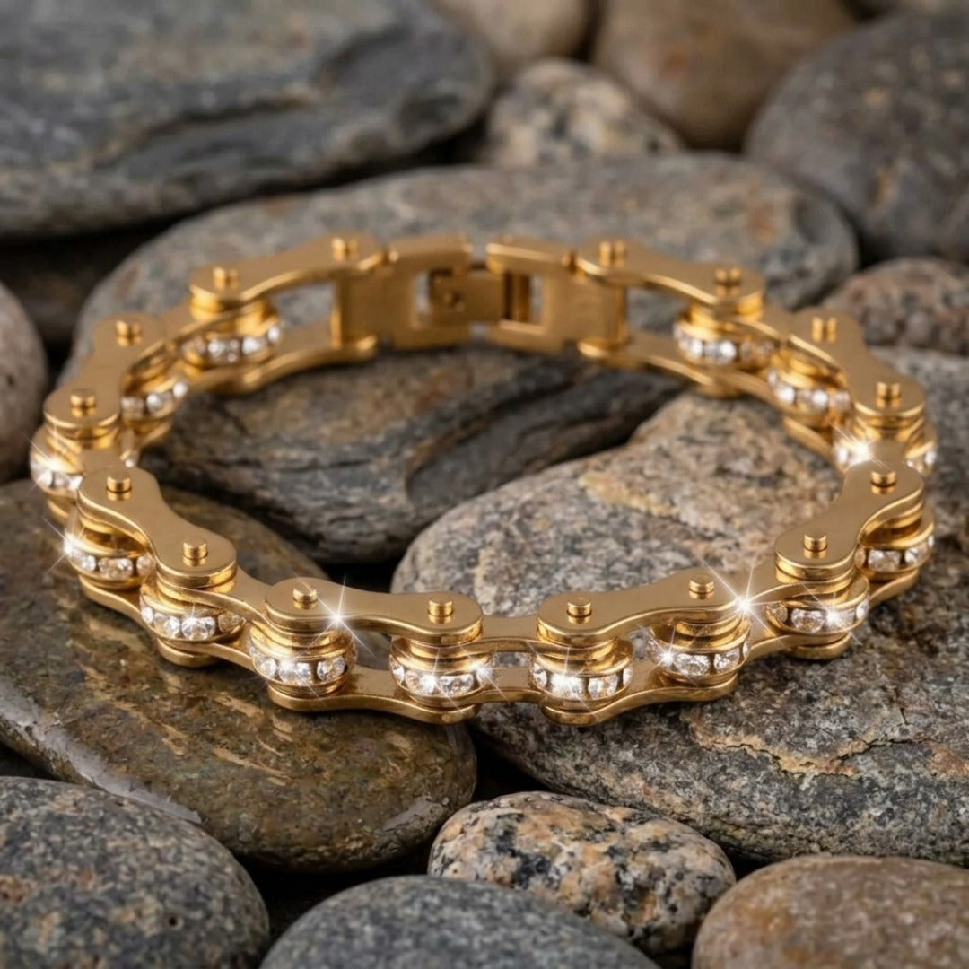 Gold chain bracelet on a bed of rocks