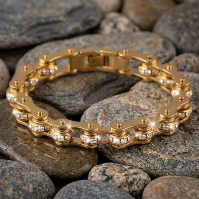 Gold chain bracelet on a bed of rocks